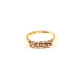 An 18ct gold and platinum illusion set five stone diamond ring,