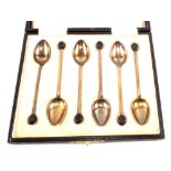 A cased set of six silver and yellow enamel coffee bean spoons