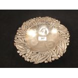 A white metal dish with floral edge