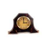 A silver and tortoiseshell table clock,