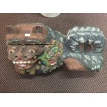 A pair of carved wooden and painted temple dogs,