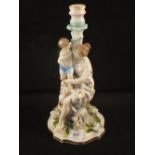 A 19th Century German porcelain lady and child candlestick,