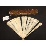 An ivory fan with intricate pierced scenes to each panel and a celluloid fan with pierced