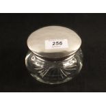 A silver top glass toilet jar