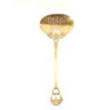 A Victorian pierced brass cream skimmer with punched and serpent decoration