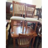A modern mahogany dining table and four chairs