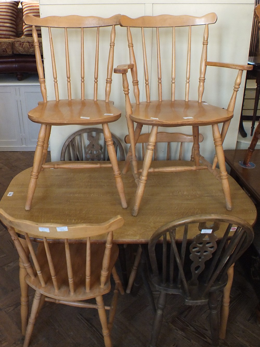 A modern oak dining table with four chairs plus two others