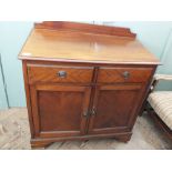 An Edwardian mahogany cupboard chest