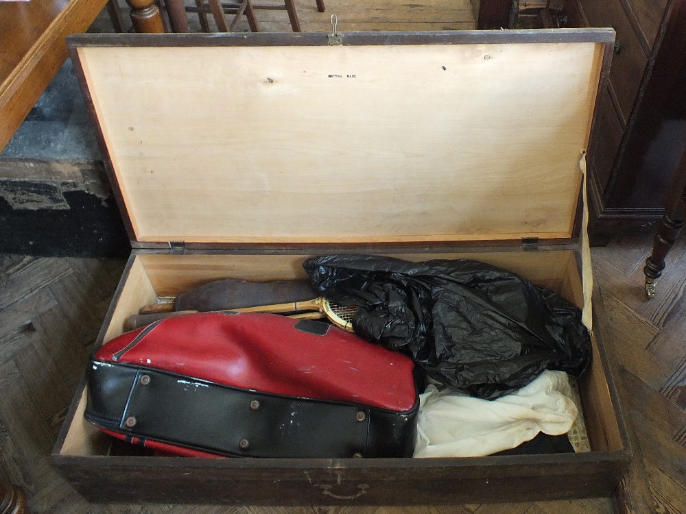 A blanket box and contents including tennis rackets,