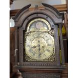 A 19th Century carved oak 8 day long cased clock with brass dial and moon roller by Wil Wilkinson,