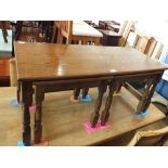 A nest of three oak occasional tables