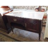An Edwardian mahogany rouge marble top washstand with single drawer and door