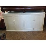 A white painted four door cupboard