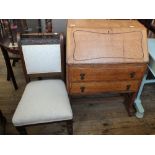 An oak two drawer bureau plus three chairs