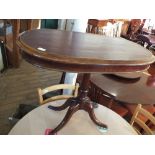 A mahogany leather top pedestal table on quadruple supports