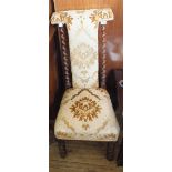 A Victorian oak nursing chair on barley twist supports