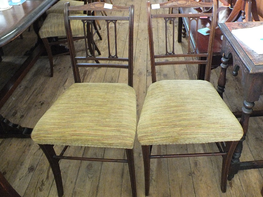 A set of four inlaid mahogany dining chairs