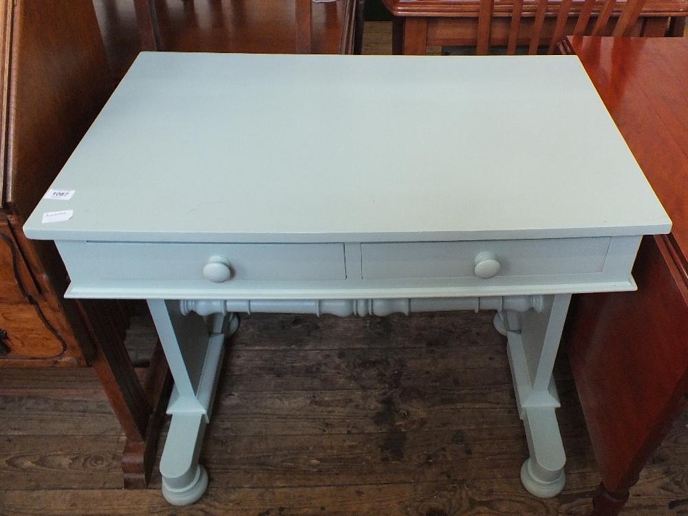 A painted two drawer stretcher table