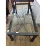 A metal based rectangular glass top coffee table