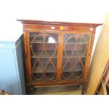 An Edwardian inlaid mahogany china cabinet with astragal glazed doors on cabriole legs