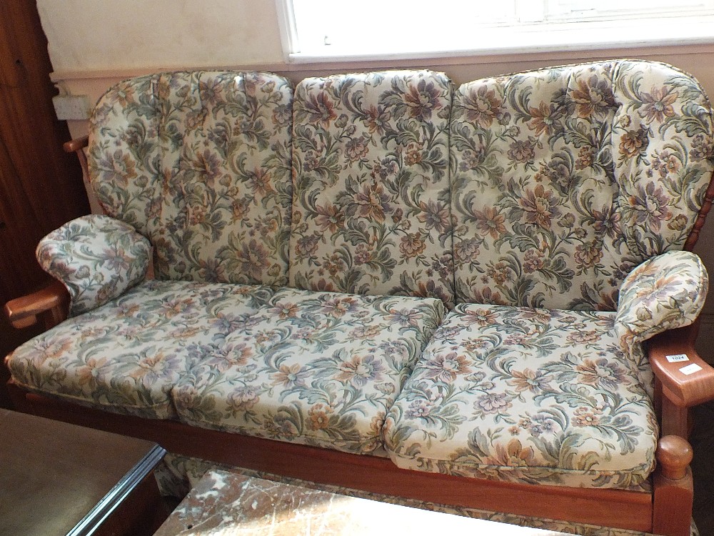 A modern floral upholstered three piece suite