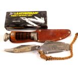 An original boxed 'leatherman' pocket tool with small sheath knife and two pocket knives