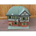 A dolls house and furniture, Triang cot,