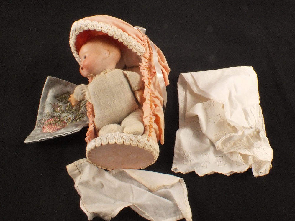 A Armand Marseille doll in cot