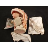 A Armand Marseille doll in cot