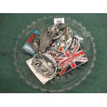 A 1935 Jubilee glass plate containing American belt buckles