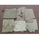 A quantity of military trousers and shirts