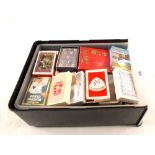 A box of various playing cards