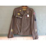 A USA 'Ike' jacket (dated 1944) full insignia for Staff Sergeant etc with trousers,