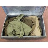 A tin trunk containing various military uniforms including WWII dated examples