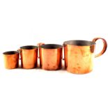 A mid 20th Century set of eight graduated copper Navy rum measures, most numbered, stamped etc,