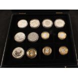 A coin case containing £2 and £5 coins and commemorative