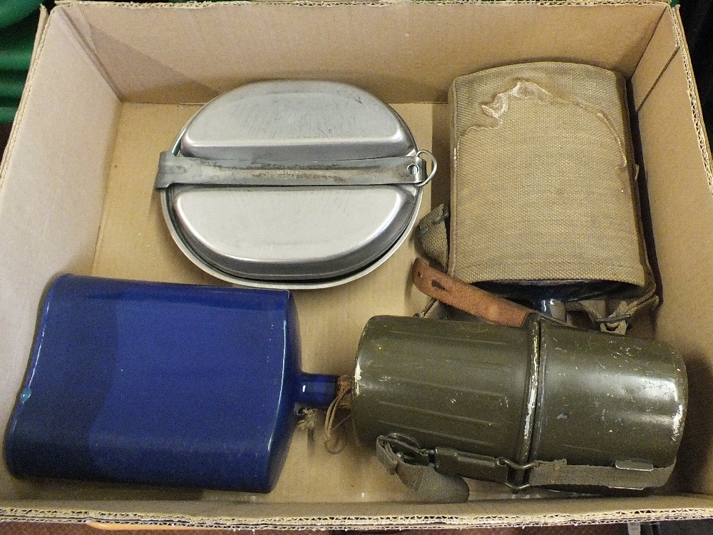 Three various water bottles including a WWI example and a set of USA mess tins with flatware