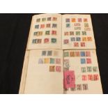 Two books containing early 20th Century stamps including many Commonwealth war tax overprints,