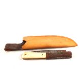 A vintage folding knife in a later leather sheath