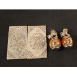 Two Chinese white metal Zodiac plaques plus a pair of white metal kylins on amber coloured balls