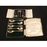 A cased set of six miniature silver spoons plus a case of five spoons