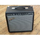 A boxed Fender Champion 40 amplifier plus a Fender Mustang two button foot switch,