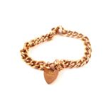 A 9ct gold curb link bracelet with heart shaped padlock clasp