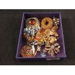 A mixed lot of costume brooches including Butler & Wilson designs