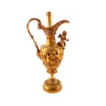 A brass ewer table lamp with cherub decoration