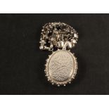 A large oval photo locket with engraved decoration with chain