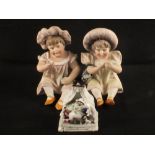 A pair of bisque seated children plus a Fairing (some damage)