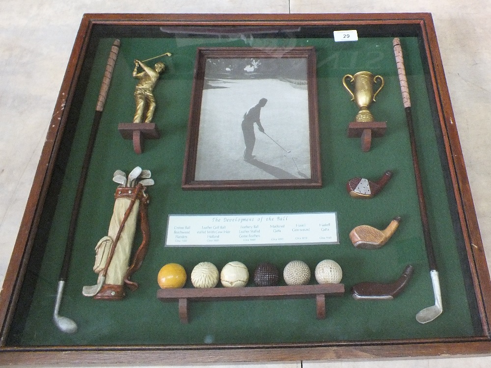 A glazed case of replica golfing items