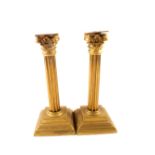 A pair of Victorian brass Corinthian column candlesticks