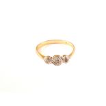 An 18ct gold and platinum three stone diamond ring,